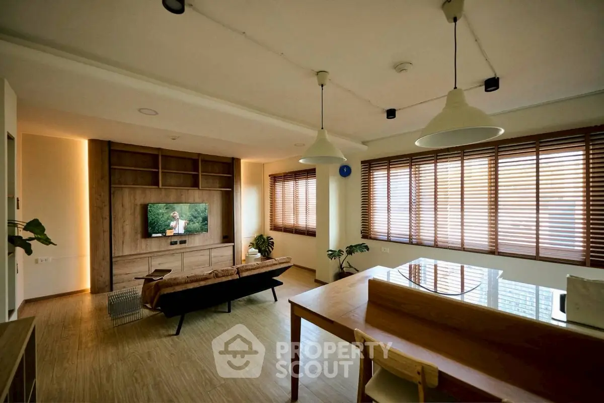 Spacious modern living room with wooden flooring and large windows