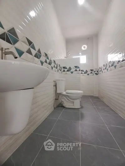 Modern bathroom with stylish tile design and sleek fixtures, perfect for a contemporary home.