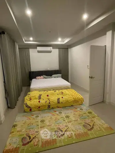 Spacious bedroom with modern decor and cozy bedding