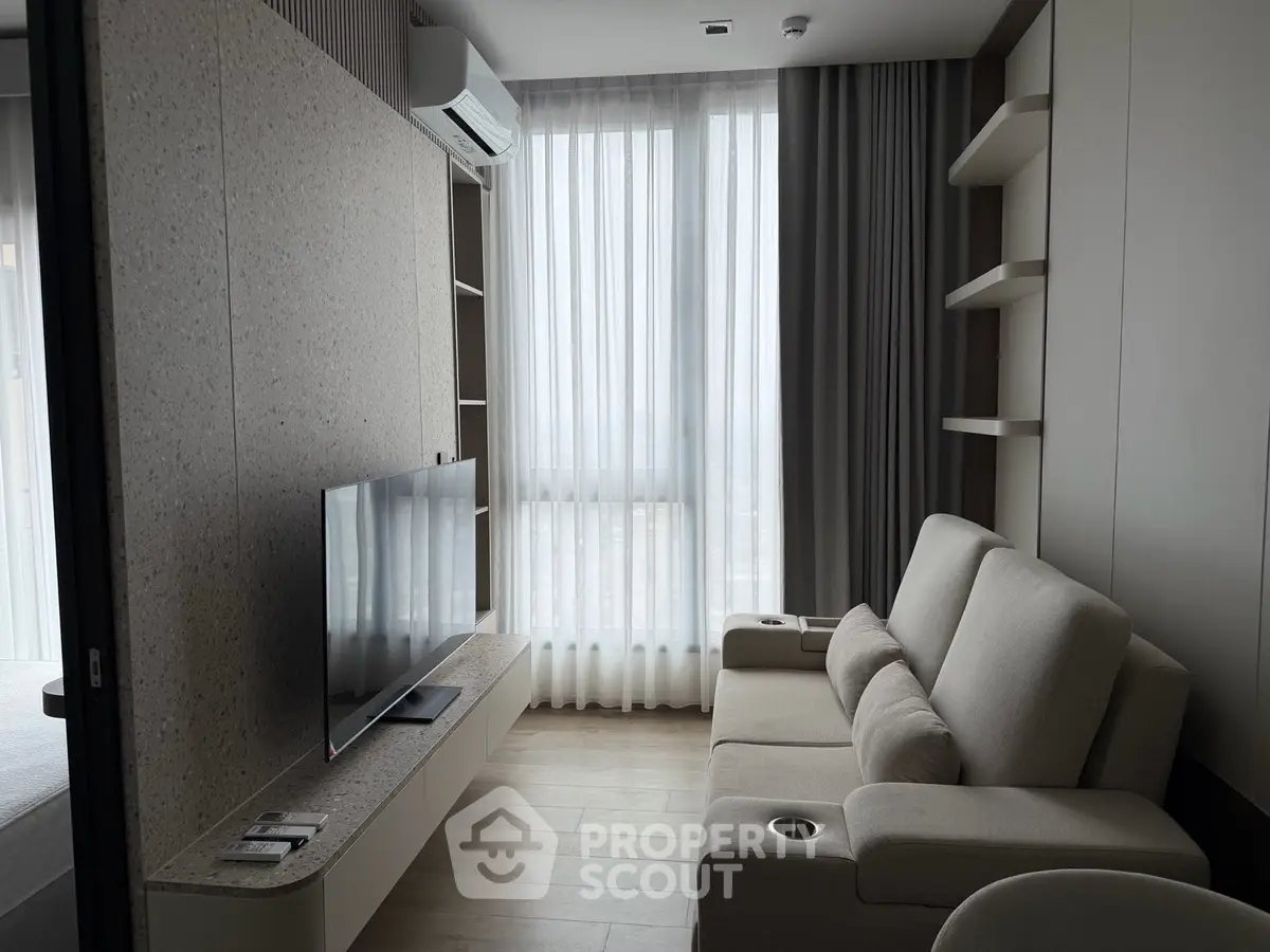 Modern living room with sleek furniture and large window for natural light