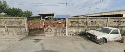Industrial property with gated entrance and parking area