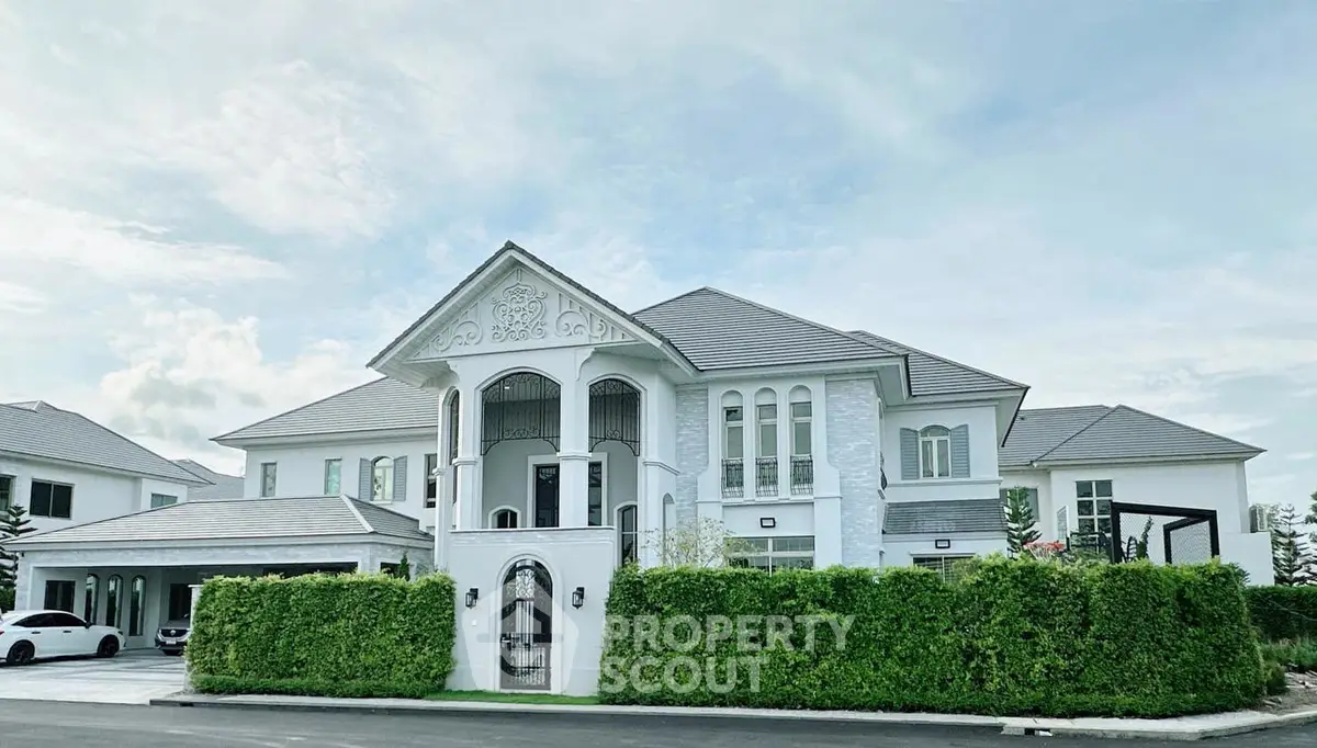 Luxurious white mansion with elegant architecture and lush greenery, perfect for upscale living.