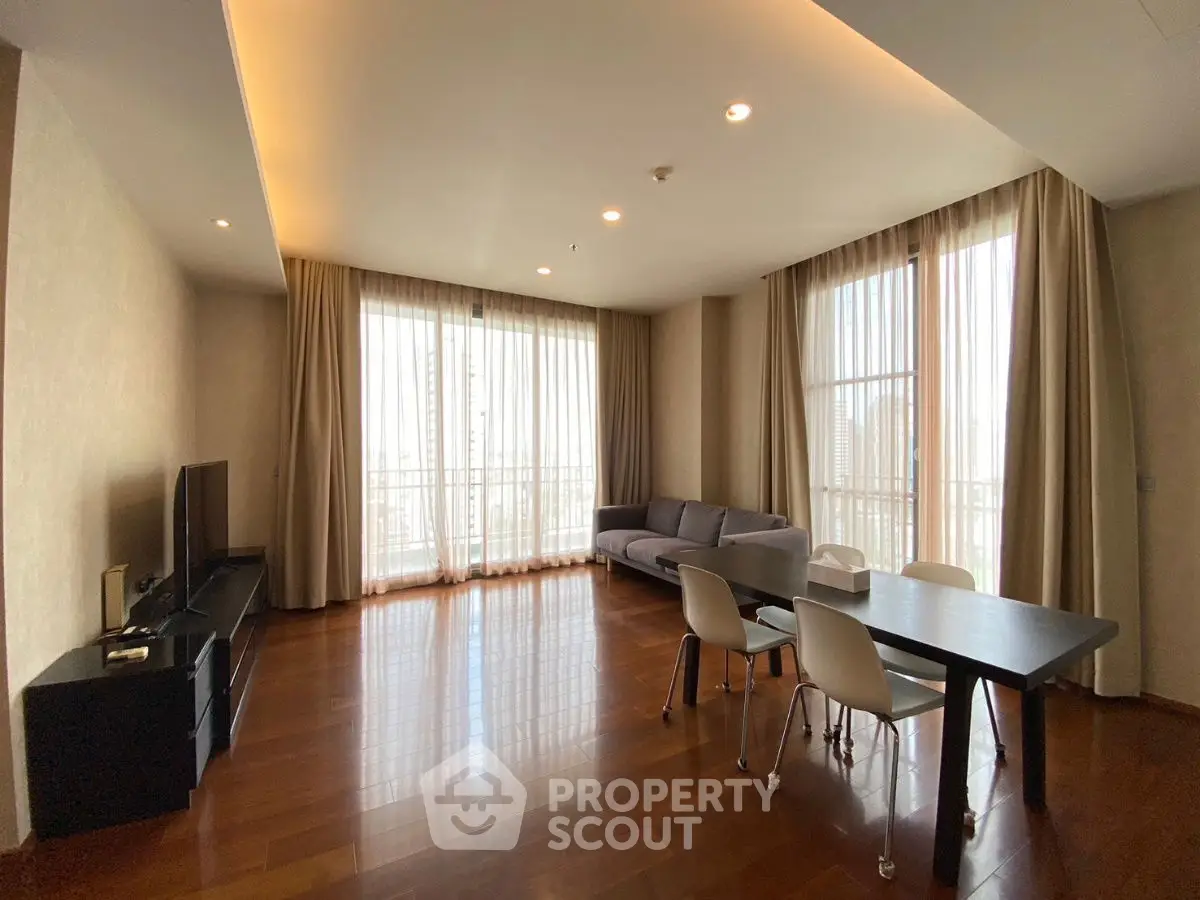 Spacious modern living room with large windows and elegant furnishings