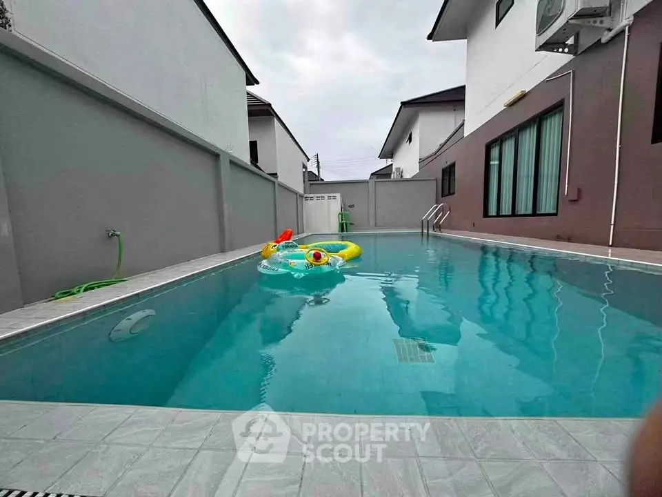 Luxurious private pool in modern residential area with pristine water and stylish surroundings.