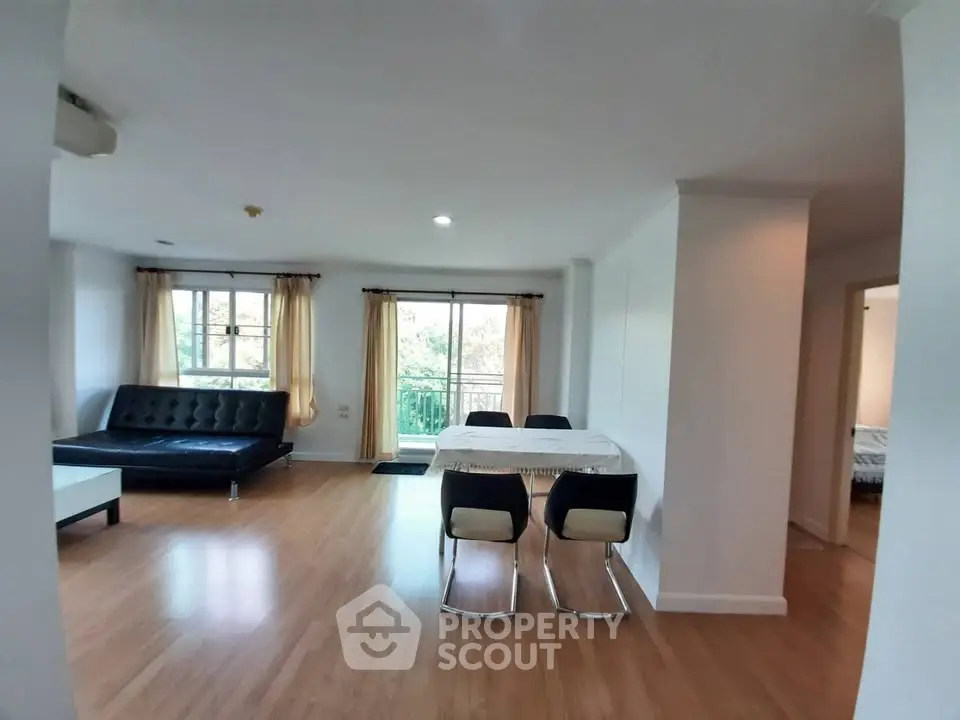Spacious open-plan living and dining area with modern furnishings and natural light.