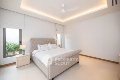 Spacious and elegant bedroom with modern design and natural light.