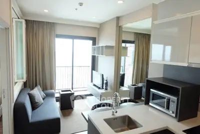 Modern living room with open kitchen and balcony view