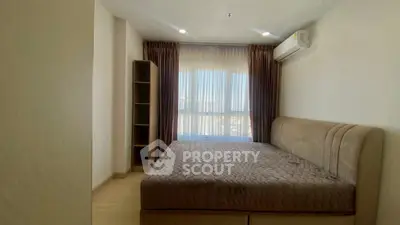 Spacious bedroom with large window and modern air conditioning unit