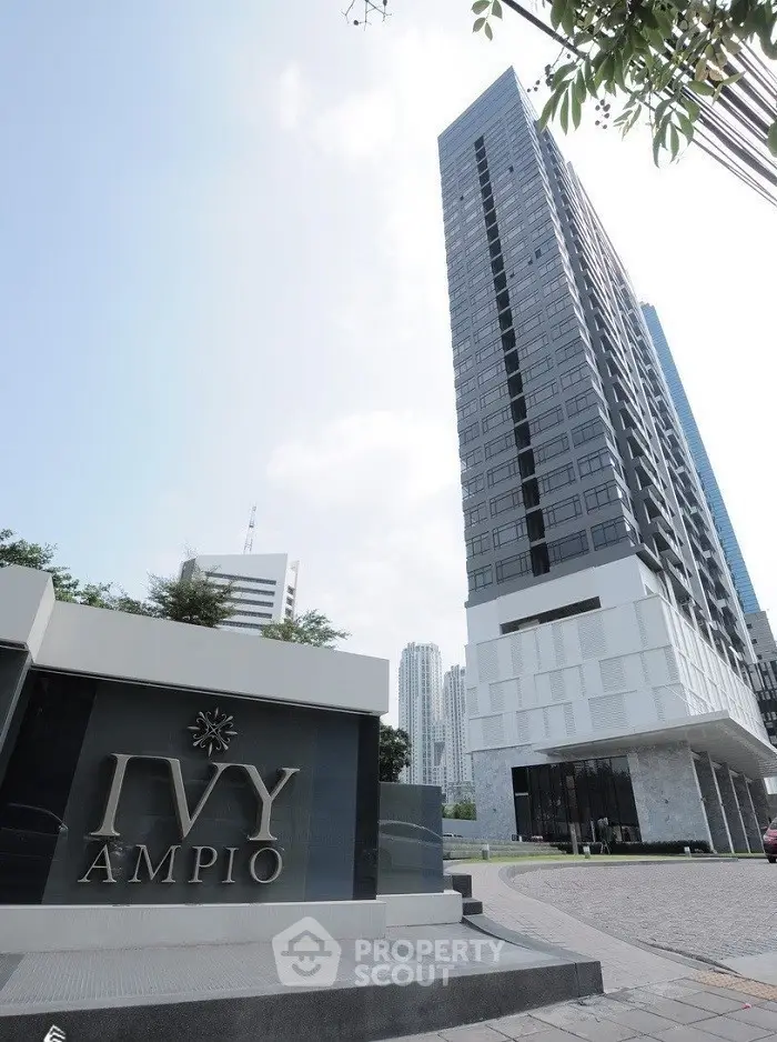 Modern high-rise building with sleek design and urban surroundings.