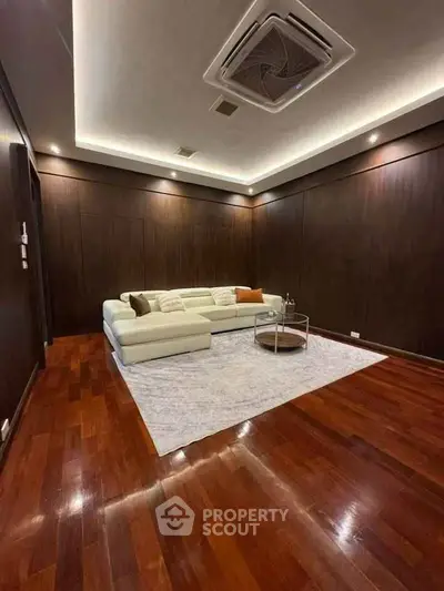 Luxurious living room with wooden flooring and modern ceiling design