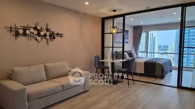 Modern open-plan living room with stylish decor and city view from bedroom.