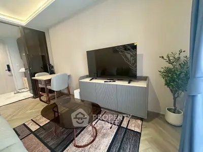 Modern living room with stylish furniture and large TV, perfect for relaxation and entertainment.