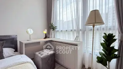 Bright and modern bedroom with large windows and elegant decor in a high-rise apartment.