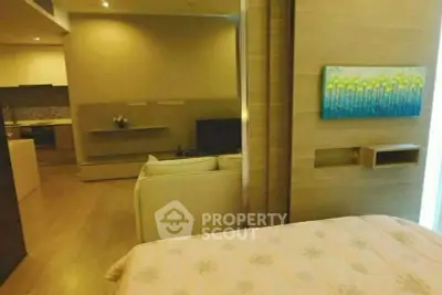 Cozy bedroom with modern decor and open layout to living area