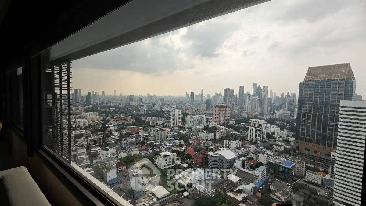 Stunning cityscape view from high-rise building window, showcasing urban skyline and architecture.