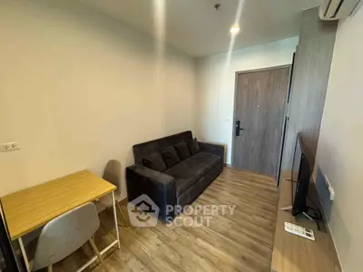 Cozy living room with modern sofa and TV, perfect for relaxation.