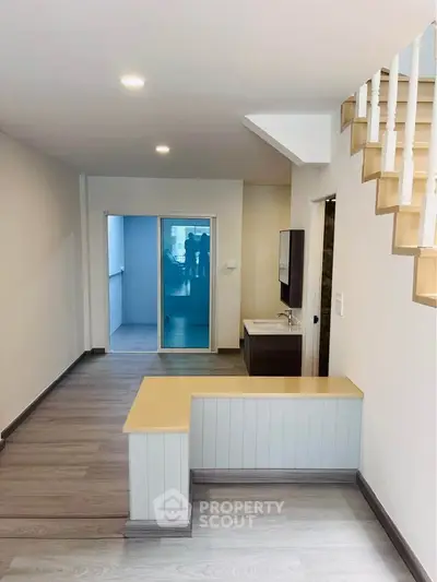 Modern interior with sleek staircase and open layout, perfect for stylish urban living.