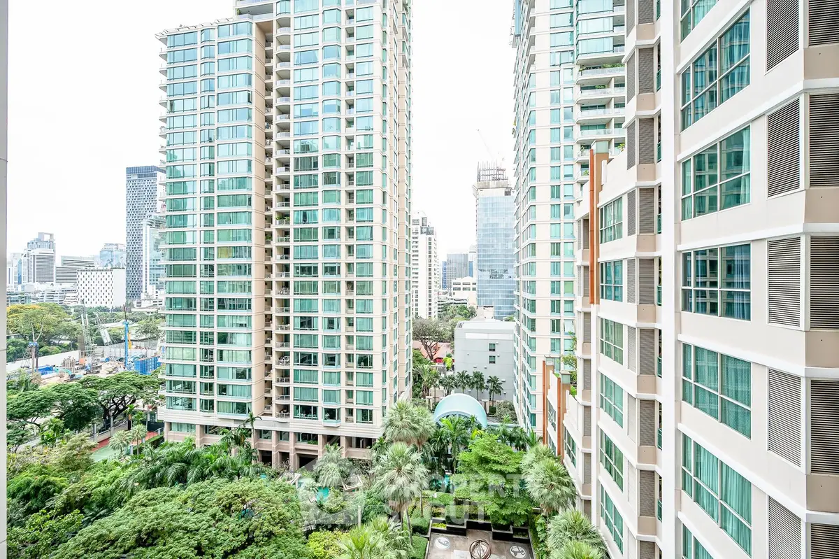 Stunning high-rise apartment buildings with lush garden views in a vibrant urban setting.