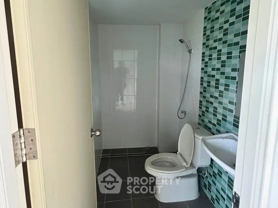Modern bathroom with stylish green tile accent wall and sleek fixtures