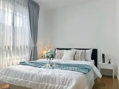 Elegant bedroom with cozy bedding and natural light