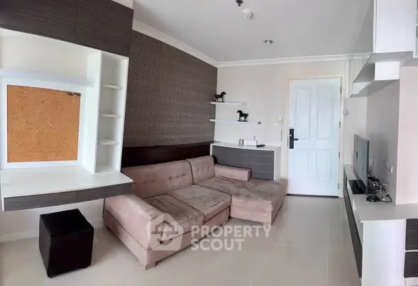Modern living room with stylish furniture and built-in shelving, perfect for cozy gatherings.