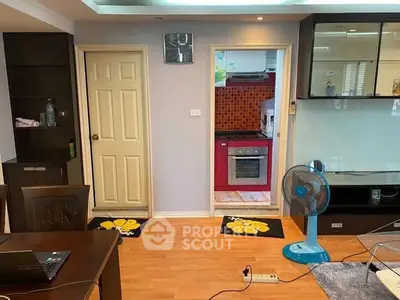 Charming interior with open kitchen layout and modern appliances in cozy living space.