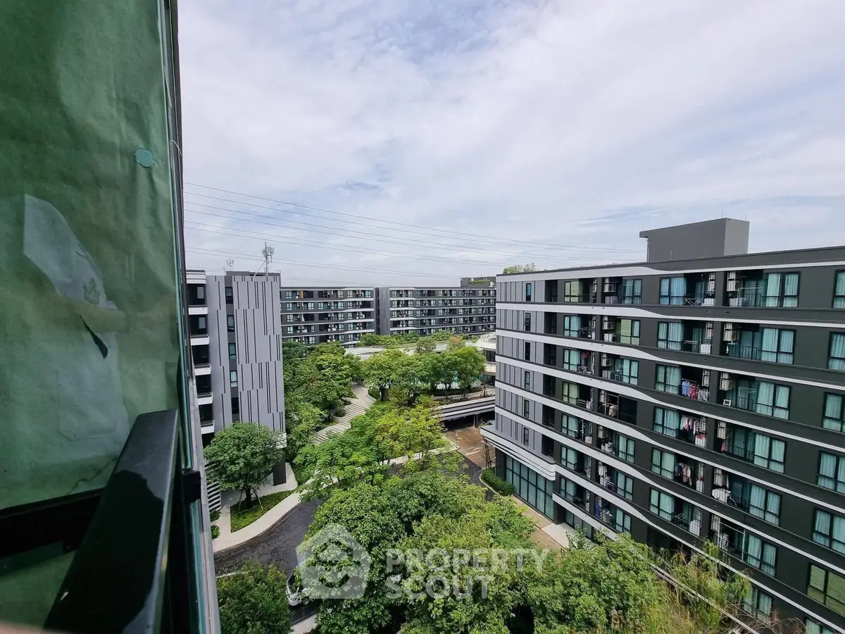 Modern apartment complex with lush greenery and spacious layout