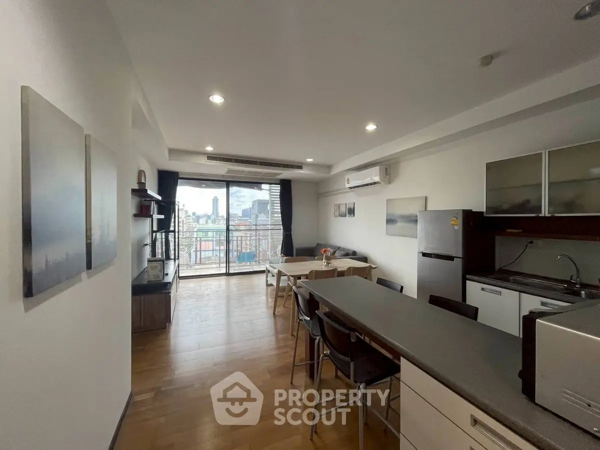 Spacious modern kitchen with open layout and city view balcony