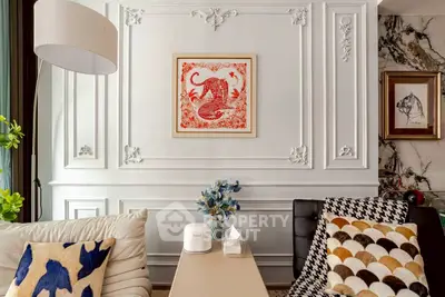 Elegant living room with stylish decor and modern furnishings, featuring a chic wall art centerpiece.