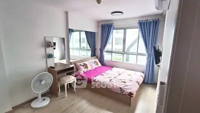 Bright and cozy bedroom with large window and modern decor