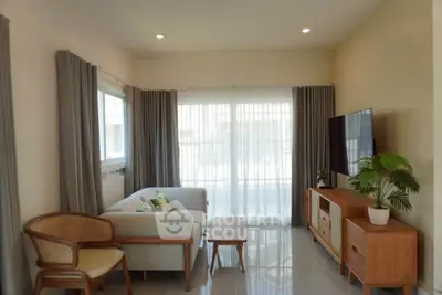 Bright and cozy living room with modern furniture and large window for natural light.