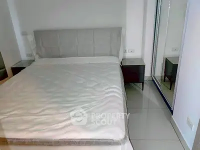 Modern bedroom with sleek design and mirrored closet doors