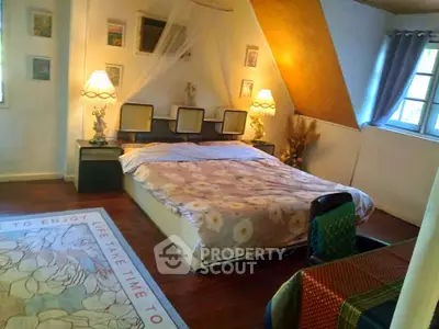 Charming bedroom with cozy decor and natural light, perfect for relaxation.
