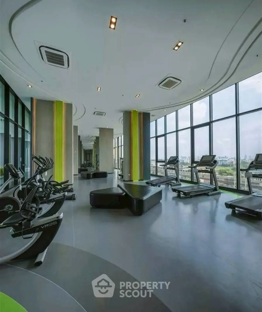 Modern gym with panoramic city views and state-of-the-art fitness equipment.