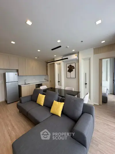 Modern open-plan living room with sleek kitchen and stylish decor