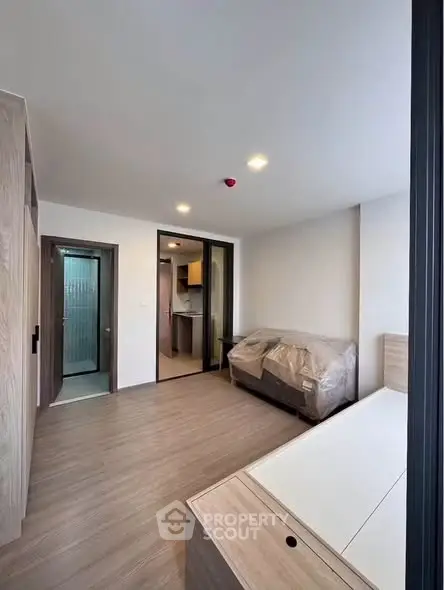 Modern living room with sleek design and natural light, featuring a cozy sofa and minimalist decor.