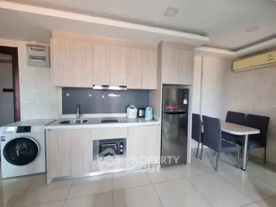 Modern kitchen with sleek appliances and dining area in stylish apartment