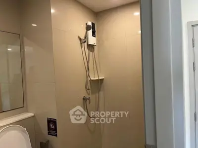 Modern bathroom with sleek shower design and neutral tiles, perfect for a contemporary home.