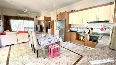 Spacious open-layout kitchen and dining area with modern appliances and stylish decor.