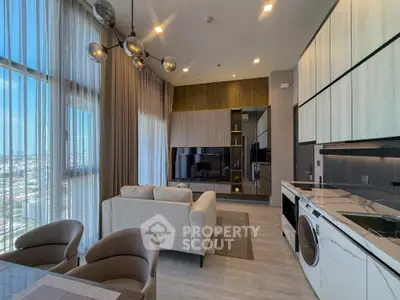 Modern open-layout living room with kitchen, featuring sleek design and city view.
