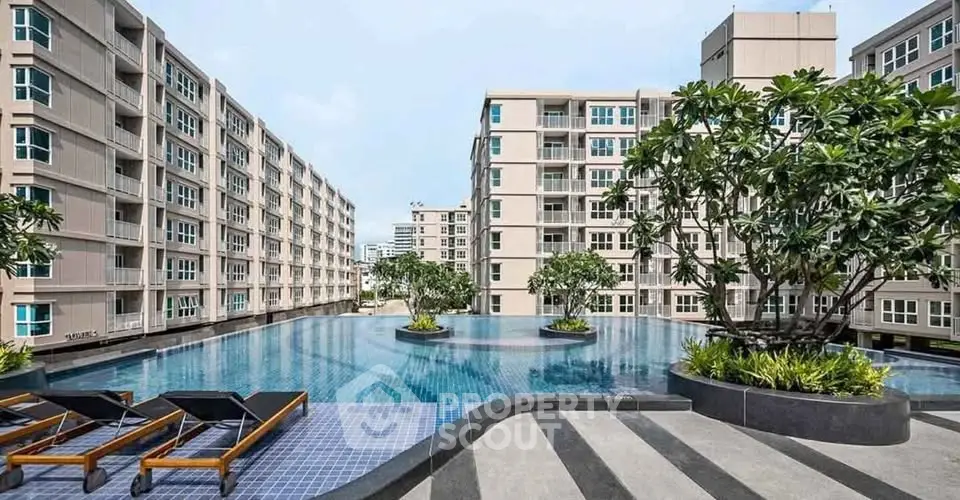 Luxurious apartment complex with stunning pool and modern architecture.