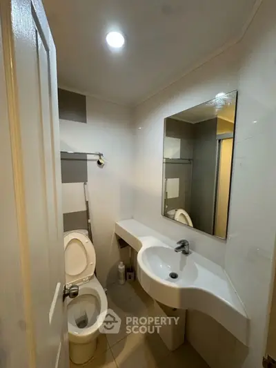 Compact modern bathroom with sleek fixtures and minimalist design