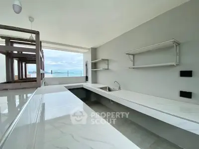 Modern open kitchen with ocean view and sleek countertops