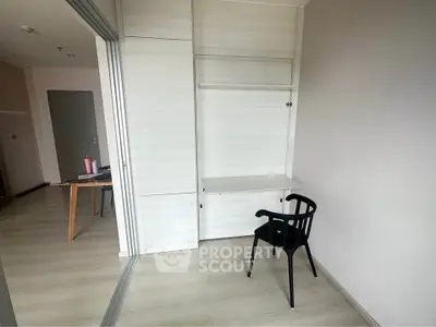 Minimalist study area with sleek chair and built-in desk in modern apartment