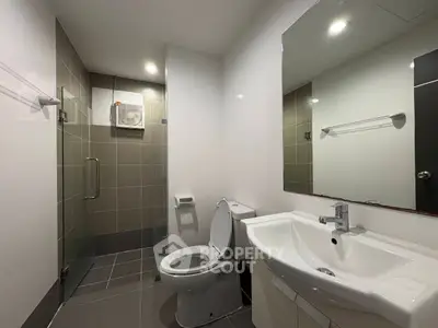 Modern bathroom with sleek fixtures and glass shower enclosure