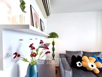 Stylish living room with modern decor, featuring a cozy gray sofa, vibrant cushions, and elegant wall art.