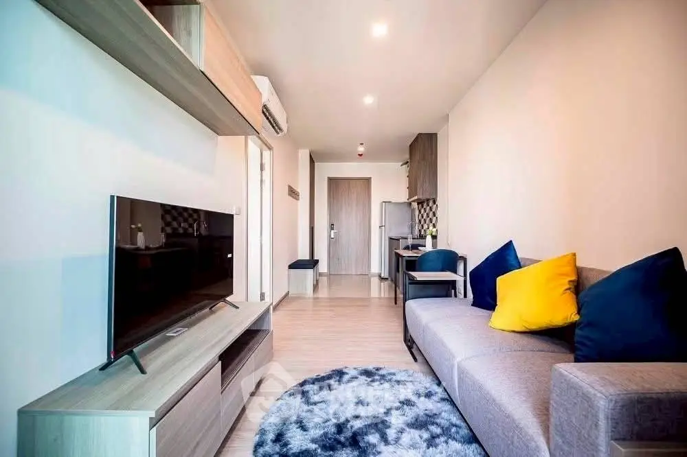 Modern living room with stylish decor and cozy seating area in a contemporary apartment.