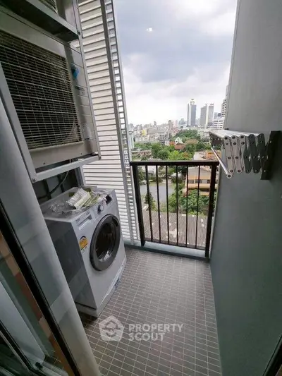 Charming balcony with city view and washing machine, perfect for urban living convenience.