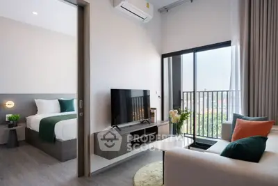 Modern living room with balcony view and stylish decor in a contemporary apartment.