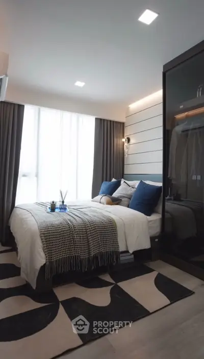 Modern bedroom with stylish decor and large window